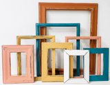 Captivating collection of mixed picture frames to curate a modern lake side cabin gallery wall in different sizes and styles.