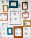 Captivating collection of mixed picture frames to curate a modern lake side cabin gallery wall in different sizes and styles.