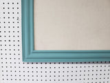 Serene lighter turquoise wall mounted bulletin with a neutral linen fabric, Available in Modern, Traditional, or Ornate Style of Frame and Small to Large Size, Agave