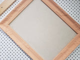 Fresh peach framed cork board for office, playroom, or girl's bedroom with a neutral linen fabric, Available in Modern, Traditional, or Ornate Frame Style in small to large sizes.