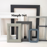 A mix and match set of vintage, shades of gray picture frames for a gallery wall, Assorted grey ombre photo frame wall collage for family memories