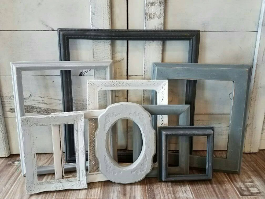 A mix and match set of vintage, shades of gray picture frames for a gallery wall, Assorted grey ombre photo frame wall collage for family memories